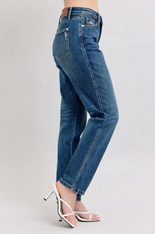 Women's high-waisted straight leg jeans with white heels, trendy denim fashion