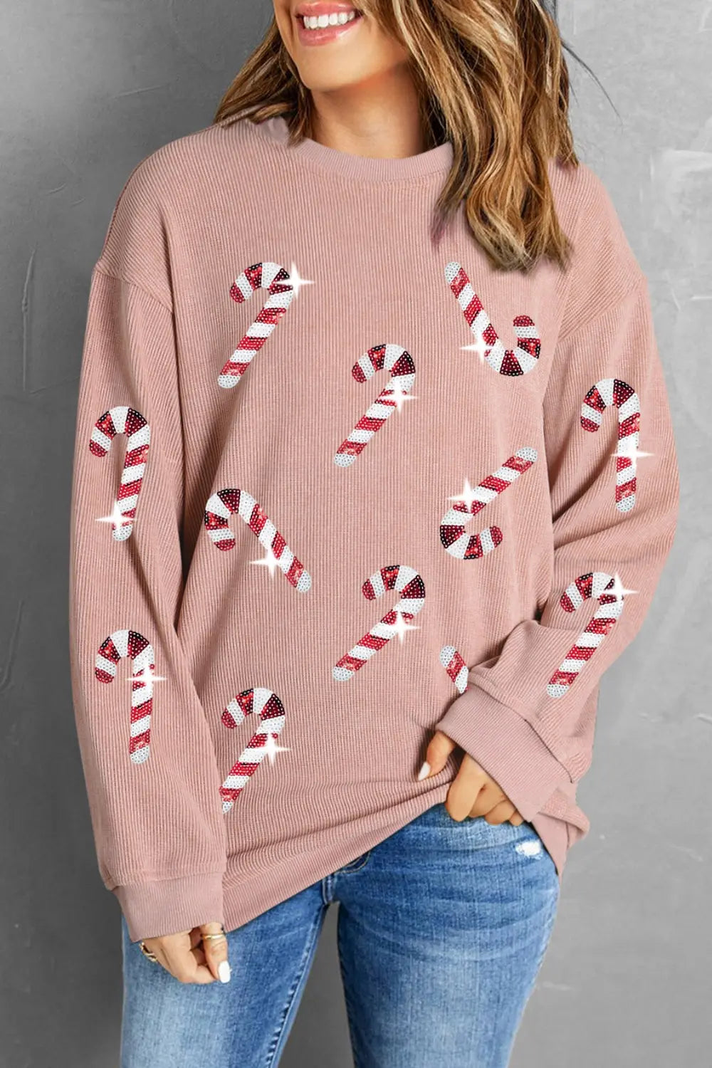 Pink sweater with candy cane print, festive holiday top for women