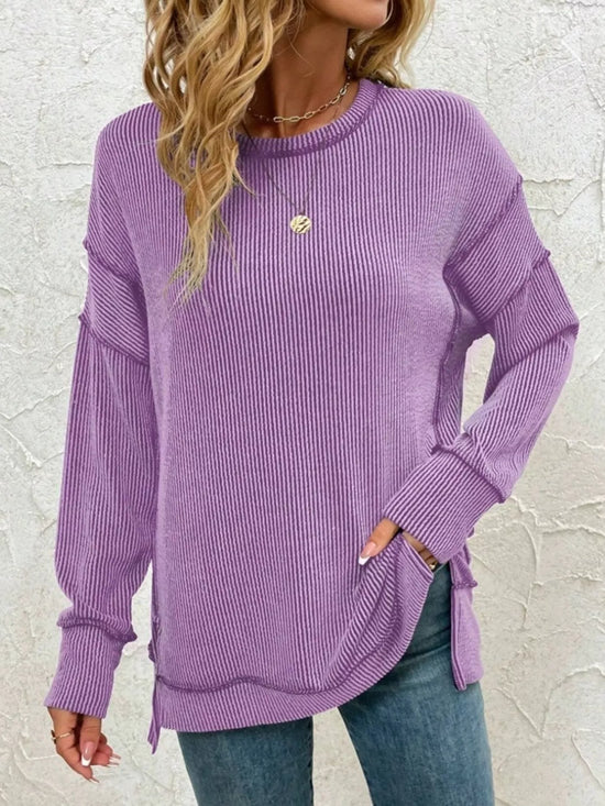 Purple ribbed long sleeve top with side slits, paired with jeans for casual women's fashion