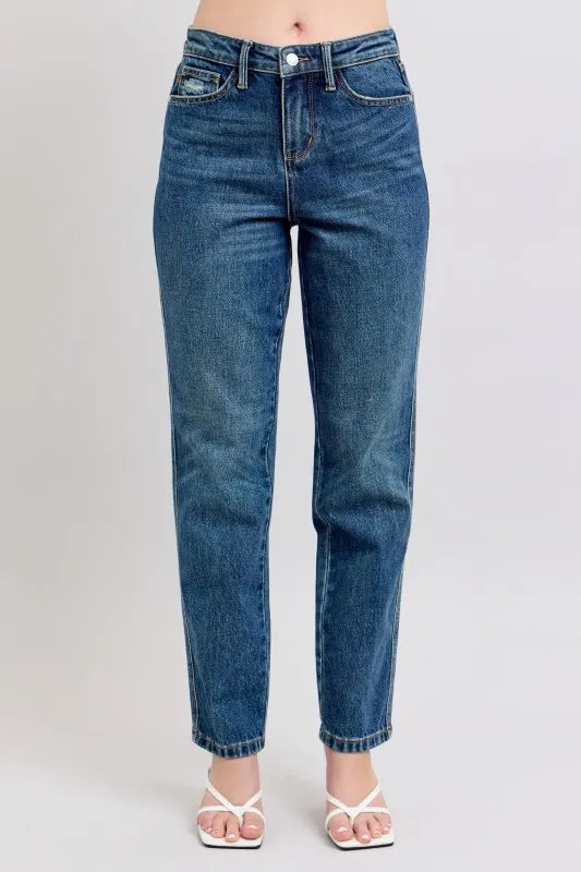 High-waisted blue jeans with straight leg fit, paired with white sandals for casual women's fashion