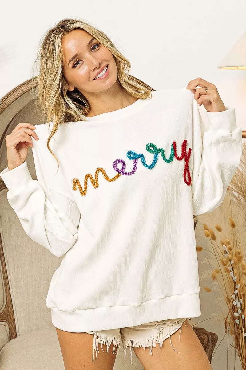 White cozy sweater with colorful 'merry' embroidery, perfect for festive women's fashion