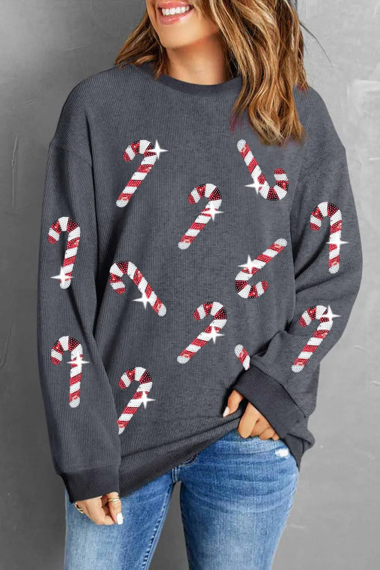 Gray sweater with red and white candy cane print, paired with blue jeans for festive holiday style.