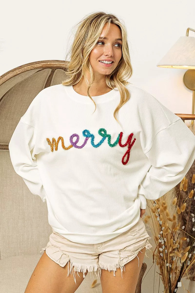 White cozy sweatshirt with colorful 'merry' embroidery, perfect for festive women's fashion