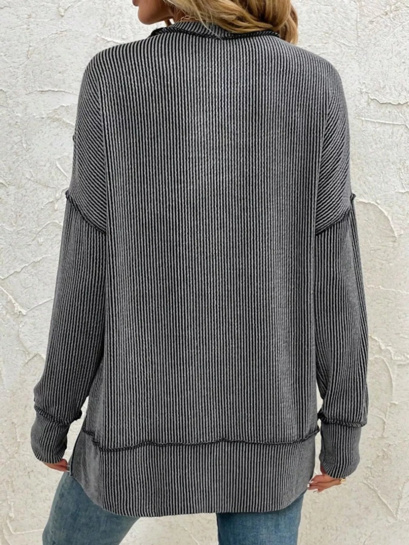 Gray ribbed long sleeve top with relaxed fit, back view, paired with jeans for casual women's fashion