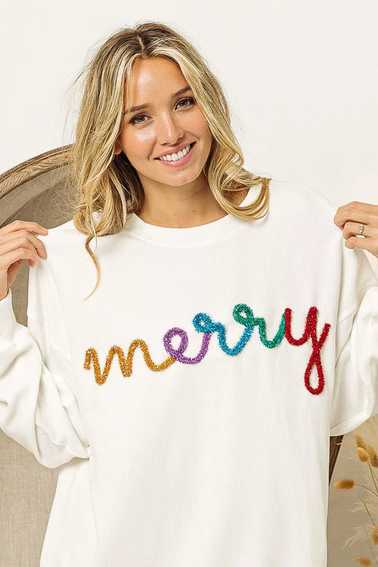 White cozy sweater with colorful 'merry' embroidery, perfect for festive women's fashion.