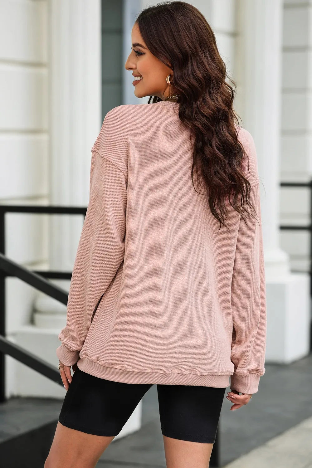 Pink ribbed long sleeve top with black biker shorts, trendy women's fashion